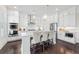 Modern kitchen featuring white cabinets, stainless steel appliances, and a breakfast bar at 3330 Carswell Bnd, Cumming, GA 30028
