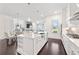 Open kitchen with a large island, stainless steel appliances, and an adjacent dining area and living space at 3330 Carswell Bnd, Cumming, GA 30028