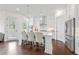 Bright, airy kitchen with white cabinets, a center island with seating, and modern stainless steel appliances at 3330 Carswell Bnd, Cumming, GA 30028