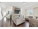 Bright living room featuring a stone fireplace, large windows, and comfortable seating areas at 3330 Carswell Bnd, Cumming, GA 30028
