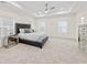 Large main bedroom featuring a tray ceiling, ceiling fan, plush carpet, and plenty of natural light at 3330 Carswell Bnd, Cumming, GA 30028