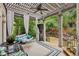 Outdoor living space with a covered patio, swing, and views of the landscaped backyard at 3665 Pennington Rd, Cumming, GA 30041