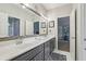 Bathroom featuring double sinks, a large mirror, and plenty of storage space at 3665 Pennington Rd, Cumming, GA 30041