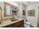 Cozy bathroom with a decorative mirror, a vanity with a granite top and neutral walls at 3665 Pennington Rd, Cumming, GA 30041