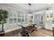 Bright dining area with a farmhouse table, bench seating, and natural light from large windows at 3665 Pennington Rd, Cumming, GA 30041