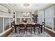 Elegant dining room featuring a chandelier, wainscoting, and a neutral color palette at 3665 Pennington Rd, Cumming, GA 30041