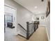 Hallway with carpet floor, dark railings and doors to bedroom and office at 3665 Pennington Rd, Cumming, GA 30041