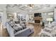 Cozy living room featuring a stone fireplace, built-in shelving, and hardwood floors at 3665 Pennington Rd, Cumming, GA 30041