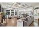 Open-concept living room features a stone fireplace, coffered ceilings, and views of the backyard at 3665 Pennington Rd, Cumming, GA 30041