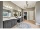 Luxurious main bathroom with double vanity, chandelier, shower, and soaking tub at 3665 Pennington Rd, Cumming, GA 30041