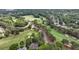 Panoramic aerial of a manicured golf course with winding paths and residential homes interspersed with trees at 119 Kennemer Ct, Johns Creek, GA 30097