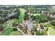 Golf course aerial with lush trees, manicured greens, and surrounding homes, perfect for golf enthusiasts at 119 Kennemer Ct, Johns Creek, GA 30097