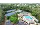 Expansive aerial view showcases tennis courts, pool, and clubhouse amidst lush greenery at 119 Kennemer Ct, Johns Creek, GA 30097