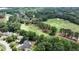 An aerial view of a golf community surrounded by lush trees, providing a scenic and tranquil setting at 119 Kennemer Ct, Johns Creek, GA 30097