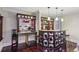 Charming bar area boasting custom cabinetry, granite countertops, barstool seating, and unique design elements at 119 Kennemer Ct, Johns Creek, GA 30097