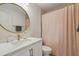 Stylish bathroom featuring a round mirror, modern vanity, and a shower with a patterned curtain at 119 Kennemer Ct, Johns Creek, GA 30097