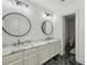 A modern bathroom showcases marble countertops, dual sinks, and elegant round mirrors at 119 Kennemer Ct, Johns Creek, GA 30097