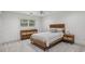A serene bedroom with neutral decor featuring a modern bed frame and dresser at 119 Kennemer Ct, Johns Creek, GA 30097