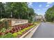 St Ives Country Club entrance with colorful flowers and landscaping, plus a charming gatehouse for a grand welcome at 119 Kennemer Ct, Johns Creek, GA 30097