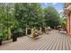 Expansive deck with ample seating, wooden swing, and lush greenery, ideal for outdoor enjoyment at 119 Kennemer Ct, Johns Creek, GA 30097