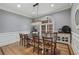 Cozy dining room showcasing crown molding, wainscoting, wood floors, and chandelier at 119 Kennemer Ct, Johns Creek, GA 30097