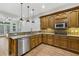 Modern kitchen with stainless steel appliances, granite countertops, and ample wooden cabinetry at 119 Kennemer Ct, Johns Creek, GA 30097