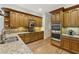 Charming kitchen with wood cabinets, granite counters, modern appliances, and wood floors at 119 Kennemer Ct, Johns Creek, GA 30097
