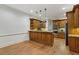 Spacious kitchen with wood cabinets, granite countertops, stainless steel appliances, and wood floors at 119 Kennemer Ct, Johns Creek, GA 30097