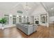 Spacious living room features vaulted ceilings, a modern gray sectional, and a fireplace with built-in shelving at 119 Kennemer Ct, Johns Creek, GA 30097