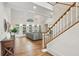 Bright living room with vaulted ceilings, a wooden staircase, and many windows that flood the room with natural light at 119 Kennemer Ct, Johns Creek, GA 30097