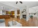 Open-concept living area featuring a fireplace, hardwood floors, and access to the kitchen at 119 Kennemer Ct, Johns Creek, GA 30097