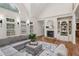 Inviting living room featuring hardwood floors, a fireplace with built-in shelving, and a cozy gray sectional sofa at 119 Kennemer Ct, Johns Creek, GA 30097