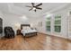 A spacious bedroom boasts a tray ceiling, hardwood floors, and ample natural light from the large windows at 119 Kennemer Ct, Johns Creek, GA 30097