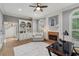 Elegant office space featuring a fireplace, built-in bookshelves, and a comfortable armchair at 119 Kennemer Ct, Johns Creek, GA 30097
