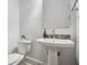 Clean and bright powder room with pedestal sink, tiled backsplash, and modern fixtures at 119 Kennemer Ct, Johns Creek, GA 30097