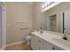 Bright bathroom with dual sink vanity, large mirror, and accessible grab bars for added safety and convenience at 8020 Woodland Ln, Alpharetta, GA 30009