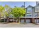 Charming multi-story townhouse with well-maintained landscaping and attached garages at 8020 Woodland Ln, Alpharetta, GA 30009