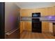 Well-equipped kitchen features stainless steel appliances, light wood cabinets, and tile backsplash at 8020 Woodland Ln, Alpharetta, GA 30009