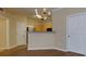 Open living room showcasing hardwood floors, a chandelier, and an open concept to the kitchen at 8020 Woodland Ln, Alpharetta, GA 30009