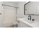 Modern bathroom featuring a tub, shower, and vanity with sleek fixtures and a contemporary design at 90 Grove Park Ln, Woodstock, GA 30189
