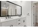 Modern bathroom with double sink vanity, black accents, large mirror, and stylish fixtures at 90 Grove Park Ln, Woodstock, GA 30189