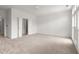 Spacious bedroom with a fan, neutral carpet, and doors leading to other rooms and offering ample space at 90 Grove Park Ln, Woodstock, GA 30189