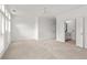 Bright bedroom with a fan, neutral carpet, and doors leading to a bathroom offering ample space at 90 Grove Park Ln, Woodstock, GA 30189