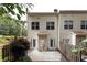 Back exterior view of townhome features a cozy patio, privacy fence, and easy access to outdoor living at 90 Grove Park Ln, Woodstock, GA 30189