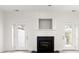 Bright living area with a fireplace, French doors, and a bar featuring granite countertops at 90 Grove Park Ln, Woodstock, GA 30189