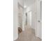 Hallway with neutral carpet with doors that lead to closets and other rooms at 90 Grove Park Ln, Woodstock, GA 30189