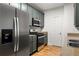 Modern kitchen showcasing stainless steel appliances, gray cabinets, and granite countertops at 90 Grove Park Ln, Woodstock, GA 30189