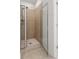 Newly remodeled bathroom with a large walk-in shower with a glass door and neutral colored tile at 90 Grove Park Ln, Woodstock, GA 30189