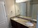 Bathroom featuring dual sinks with granite countertops, a large mirror, and modern fixtures at 3140 Tylerton Sw Dr, Atlanta, GA 30311