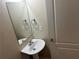 Compact half-bathroom featuring pedestal sink and basic fixtures at 3140 Tylerton Sw Dr, Atlanta, GA 30311